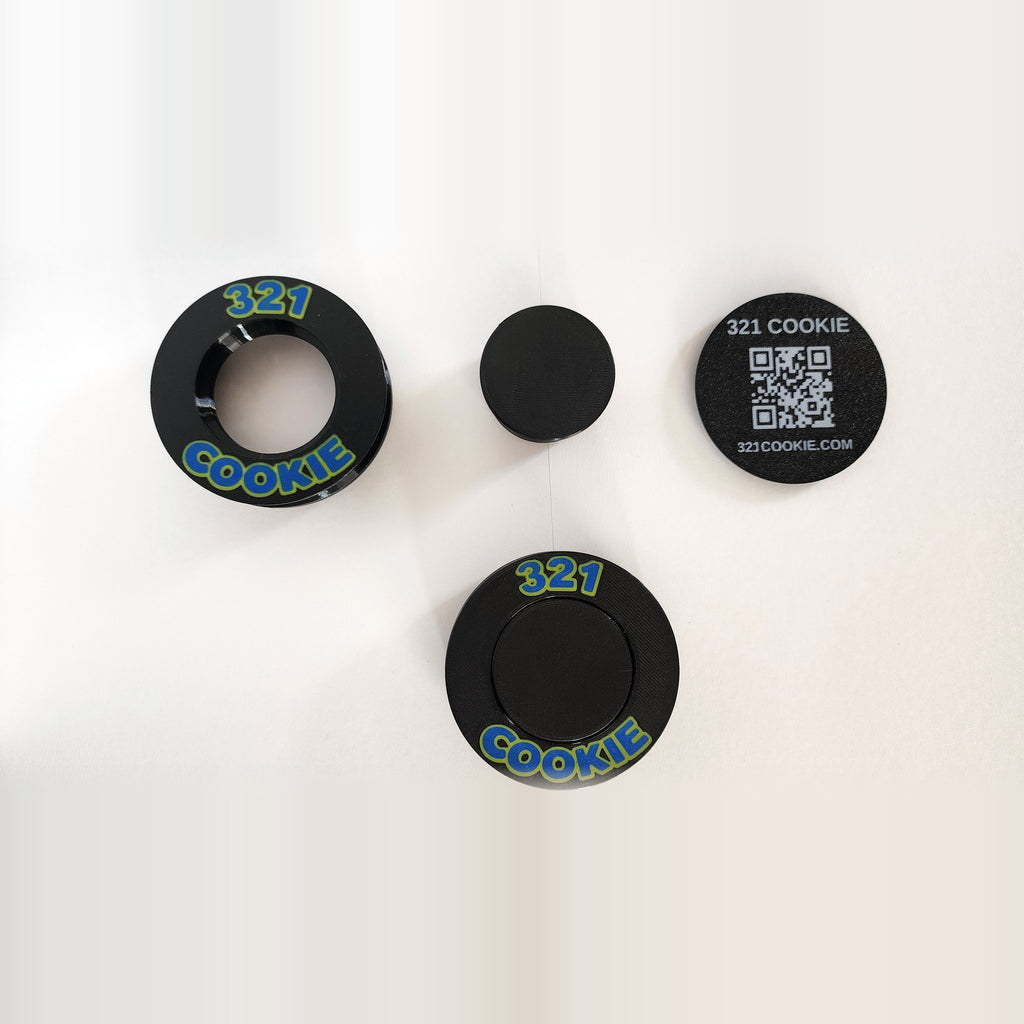 The parts of the 321 Cookie Press: cutter ring, plunger and QR backer