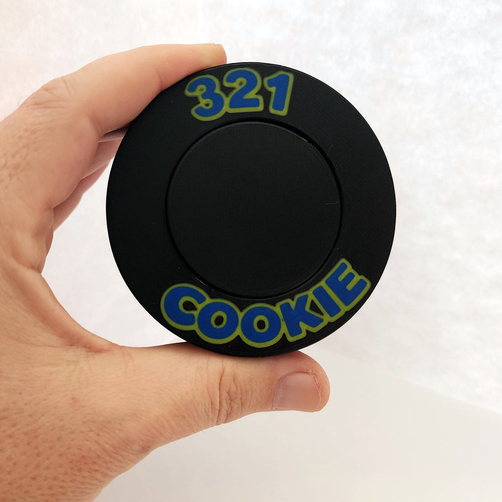 The 321 Cookie Press held in one hand to show its size