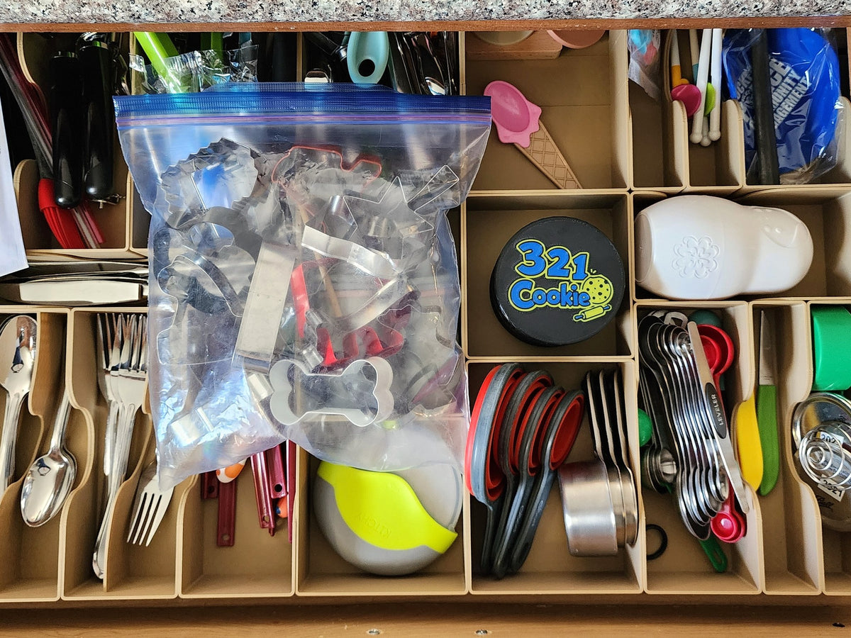 Kitchen drawer with a gallon bag of metal cookie cutters next to the Storage Stack
